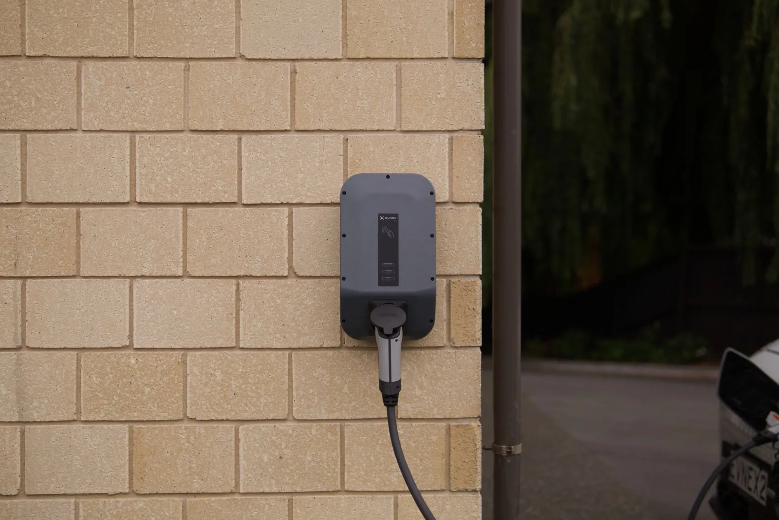 Home EV charger neatly installed on a garage wall